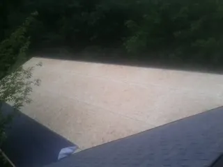 New OSB roof sheathing installed beside an existing shingle roof in Trevorton