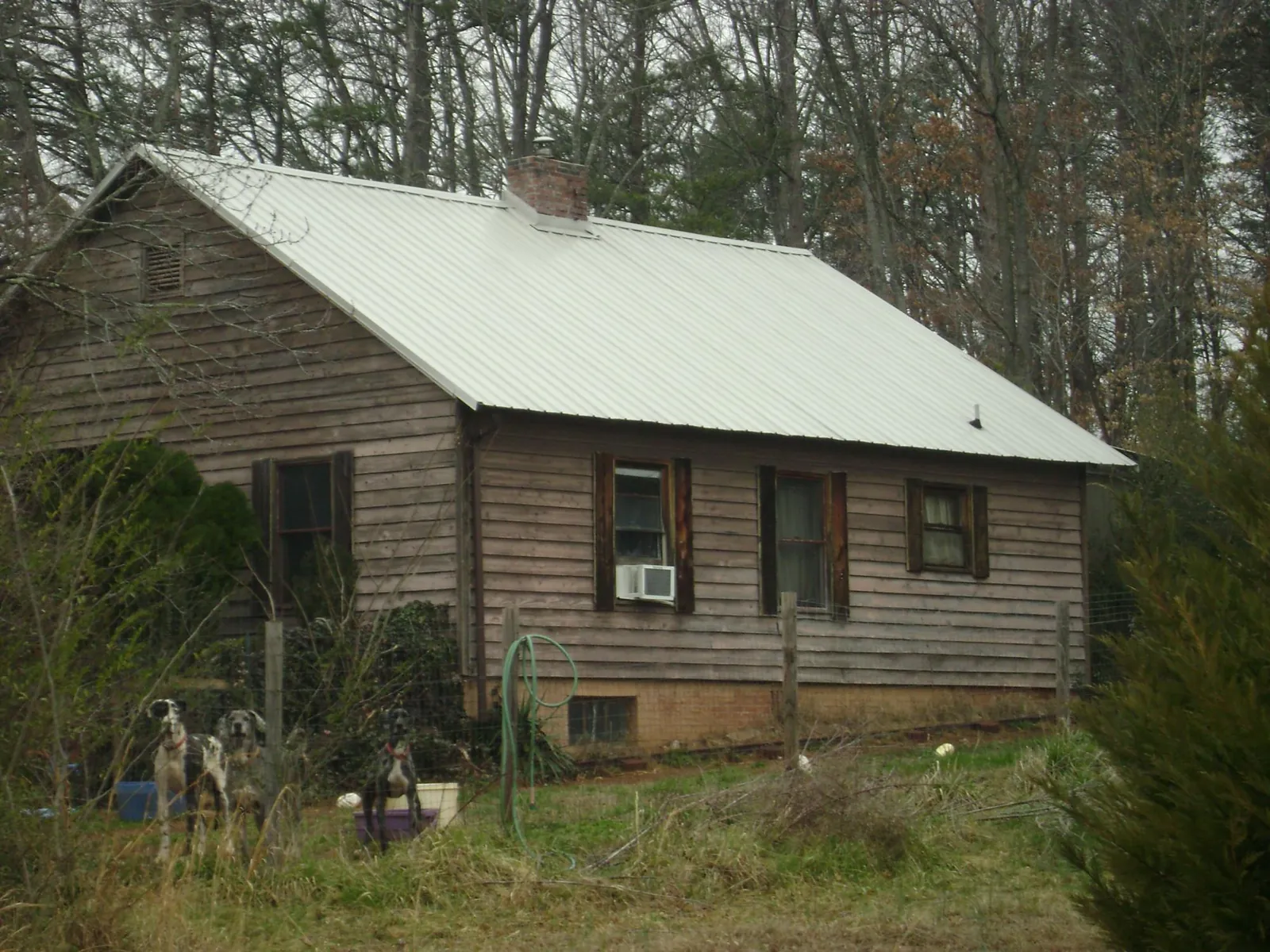 White metal roof on an old wood sided farmhouse, from a Asphalt Shingle Roof Repair job in Trevorton